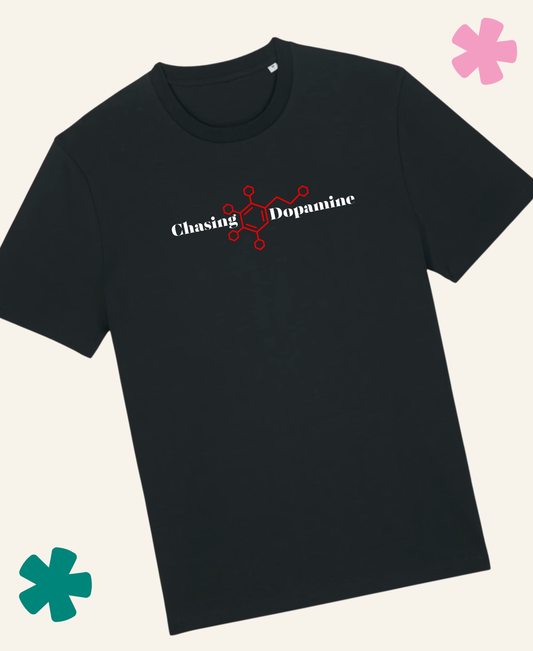 Black t-shirt with 'Chasing Dopamine' design on a light gray background
