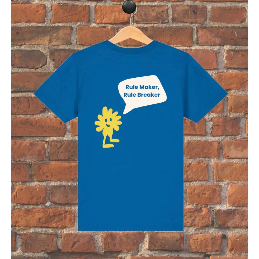 Blue t-shirt with yellow graphic and text on a wooden hanger against a brick wall.