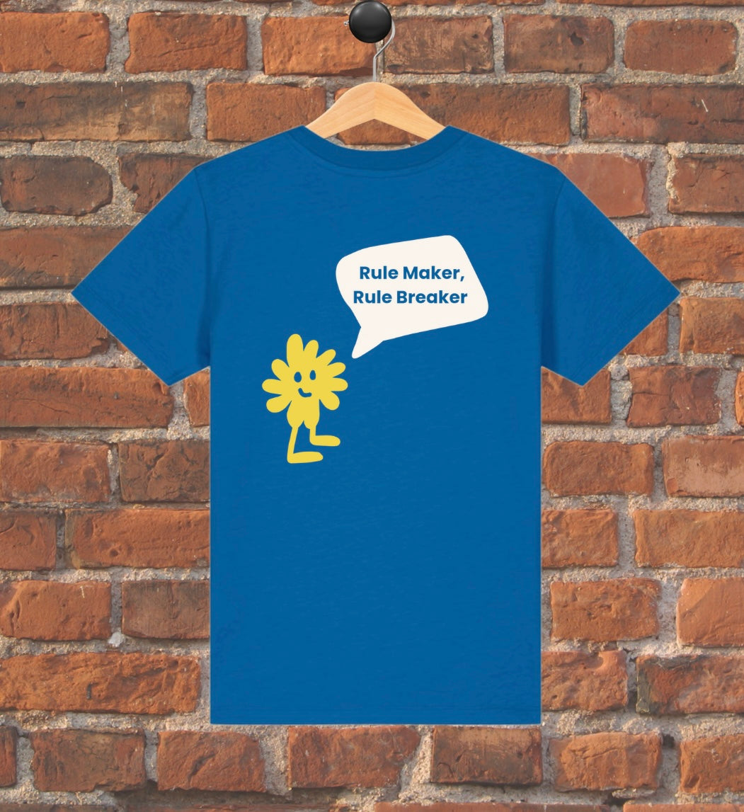 Blue t-shirt with yellow graphic and text on a wooden hanger against a brick wall.