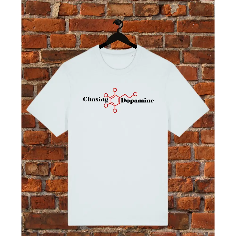 ice blue t-shirt with 'Chasing Dopamine' design on a hanger against a brick wall.