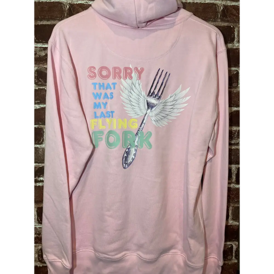 Pink hoodie with a graphic design of a fork with wings and text on a brick wall background