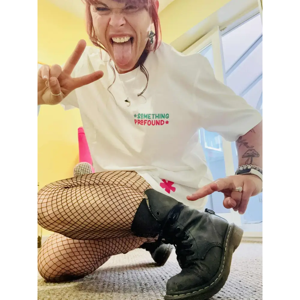 Kylie Dixon MBE wearing a Something Profound T-shirt showing off the asterisk making peace sign