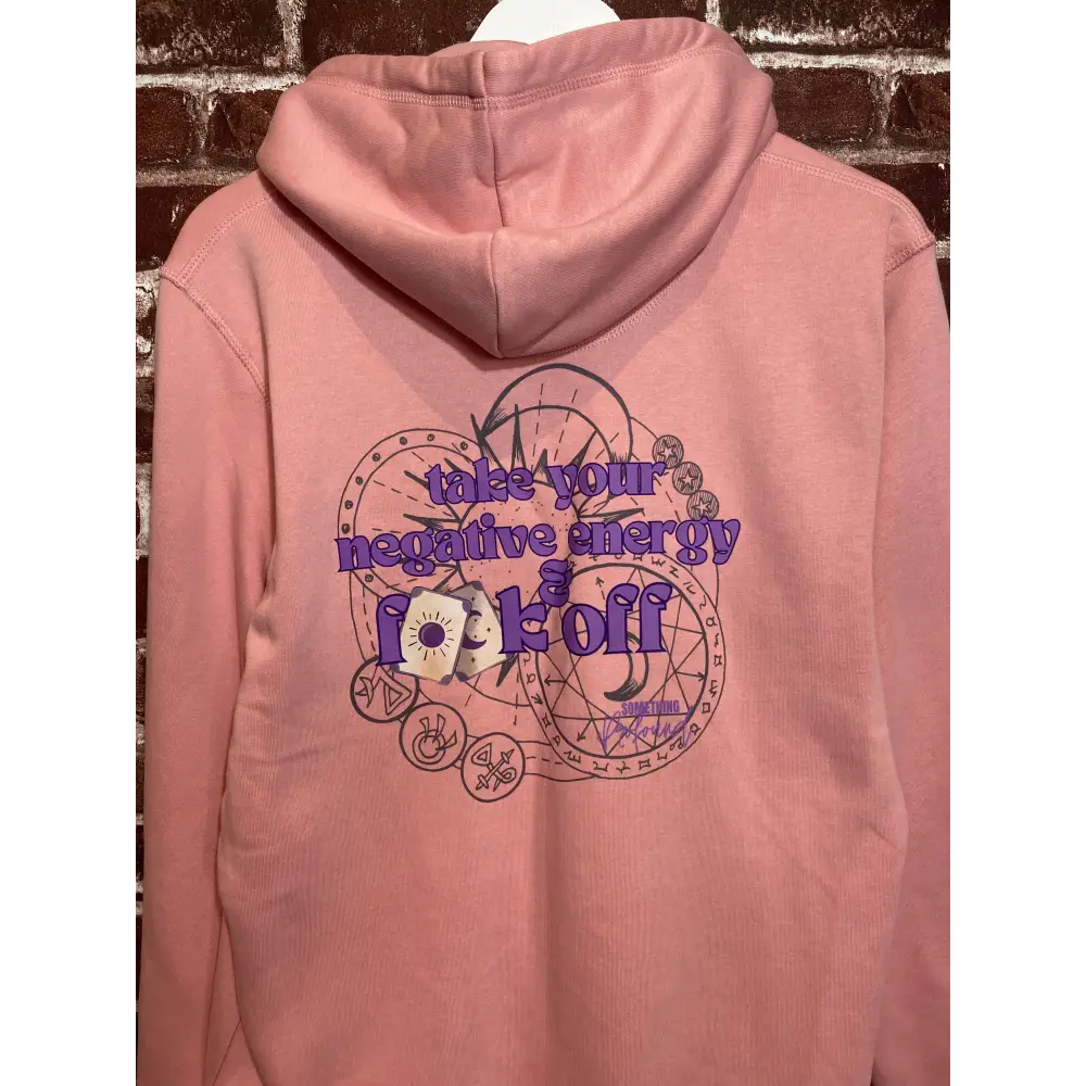Pink hoodie with a graphic design and text on a textured surface take your negative energy and f**k off