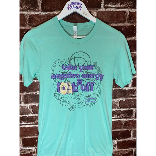 Mint green t-shirt with graphic design and text on a brick wall background