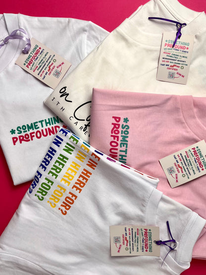 White t-shirt with colorful text and pink t-shirt with text on a pink background