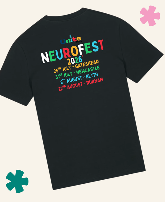 A black short-sleeve t-shirt shown from the back, featuring a colorful graphic print for 'Unite NeuroFest 2026' with concert dates listed in rainbow-colored text. The t-shirt is displayed on a light cream background with decorative pink and teal flower graphics in the corners.Unite Club x Something Profound