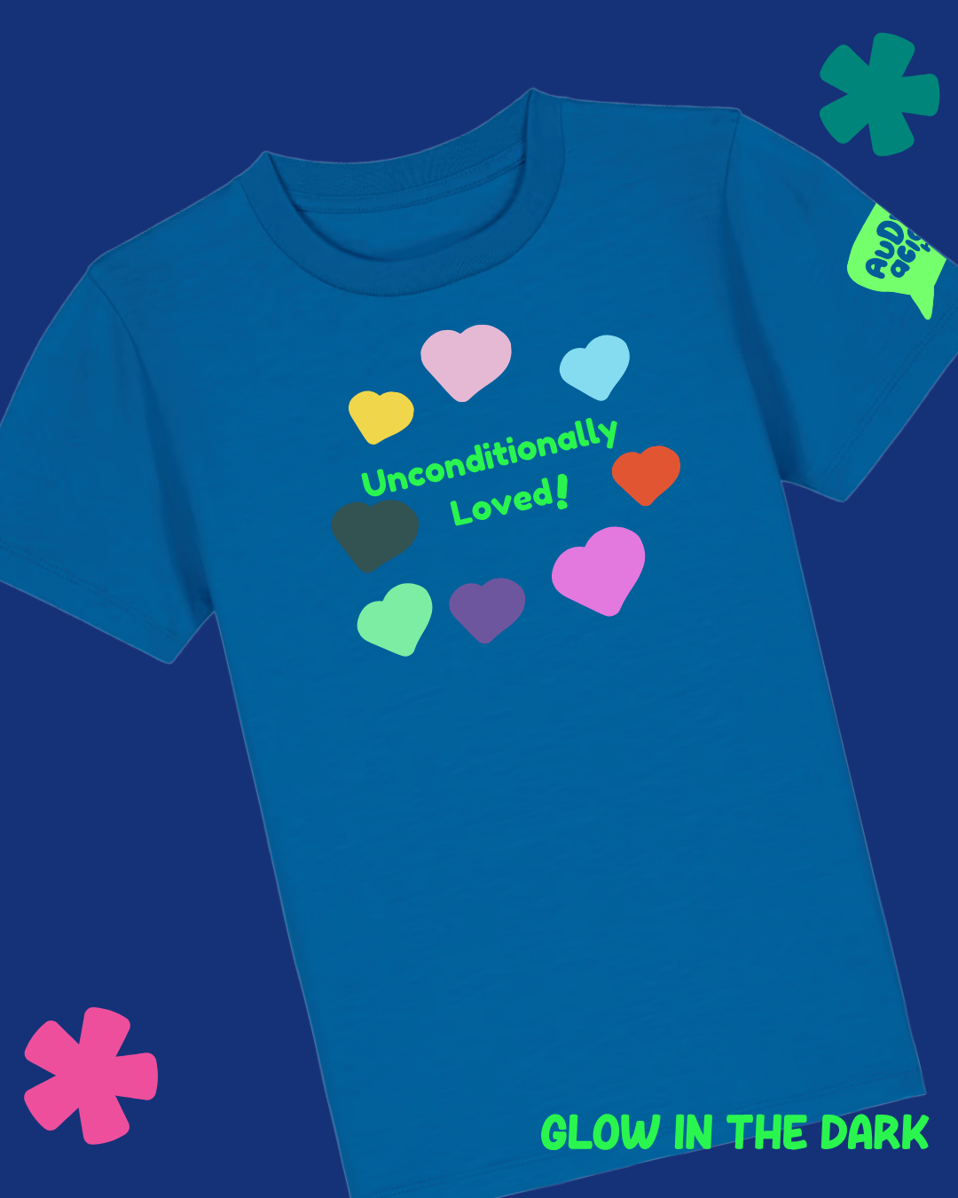 A blue short-sleeve t-shirt with a graphic of colorful hearts and the text 'Unconditionally Loved!' on the chest, plus 'GLOW IN THE DARK' text on the sleeve and bottom right corner, set against a dark blue background.