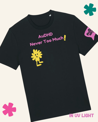 Black t-shirt with 'AuDHD Never Too Much!' text and a yellow flower graphic on a white background.