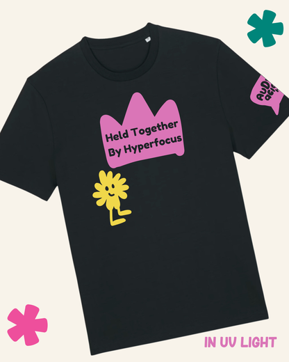 Black t-shirt with pink crown and yellow flower graphic on a white background