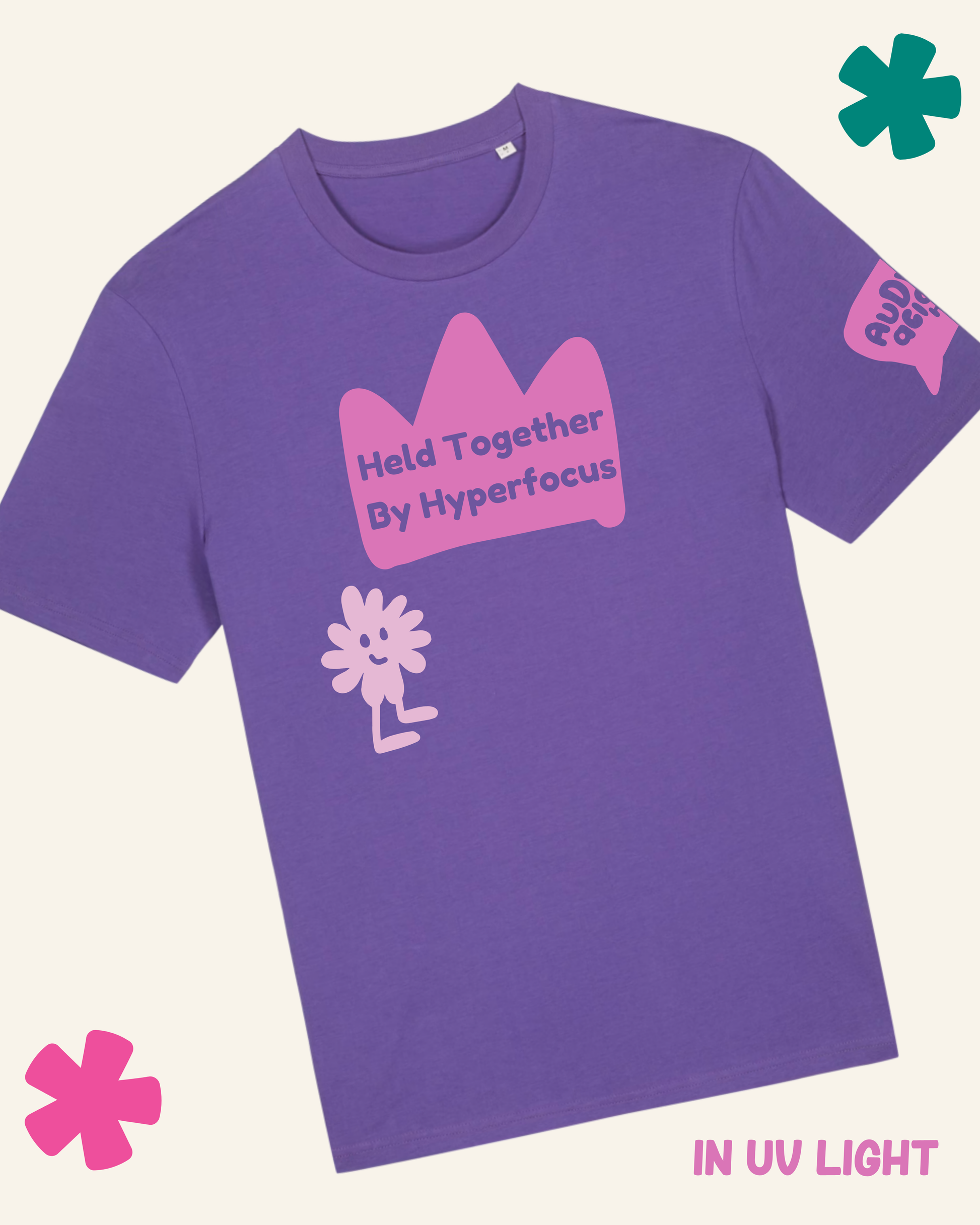 Purple t-shirt with pink graphics and text on a light gray background