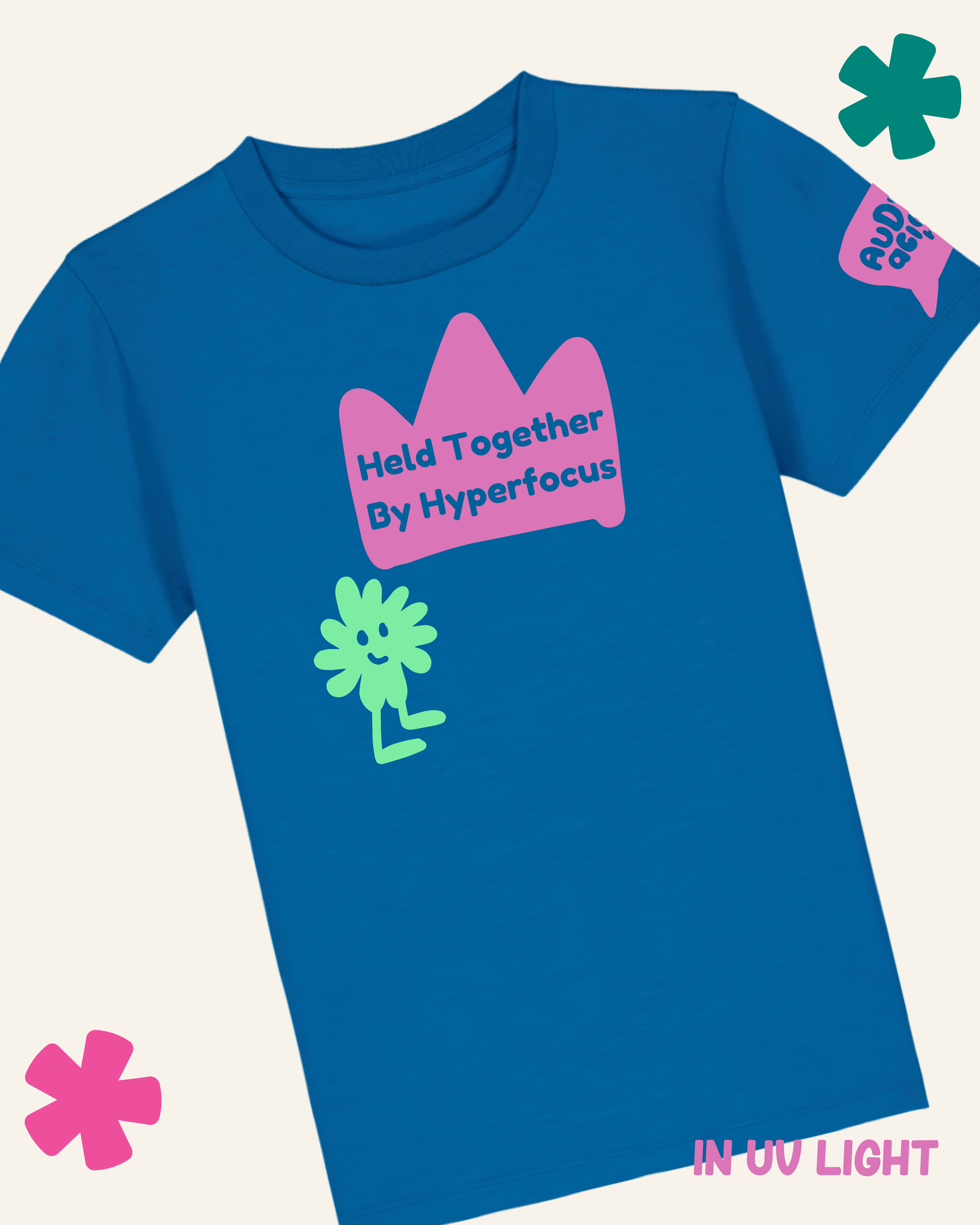 Blue t-shirt with pink crown graphic and green character, on a light gray background