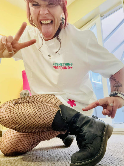 Kylie Dixon MBE wearing a Something Profound T-shirt showing off the asterisk making peace sign