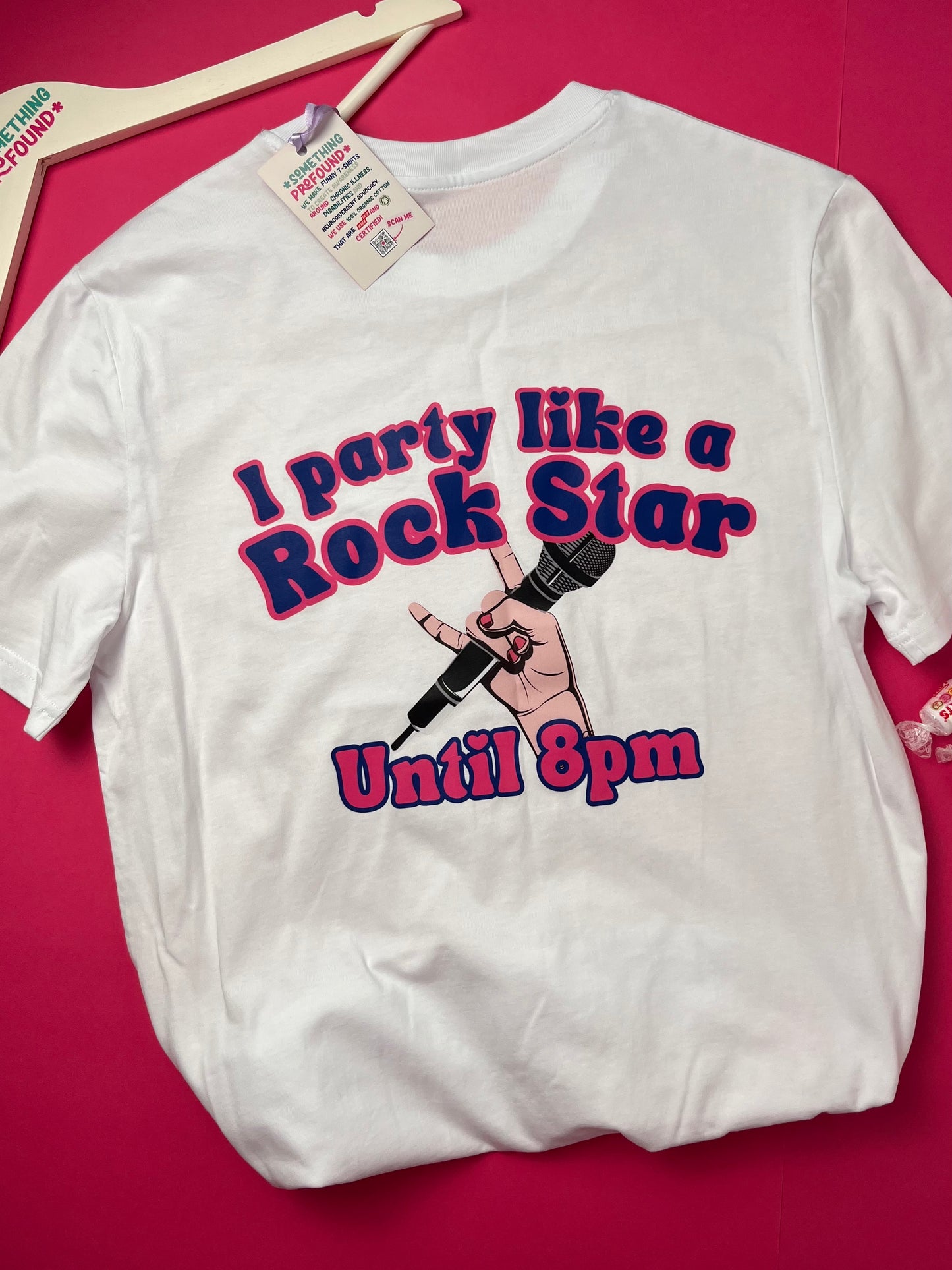 White t-shirt with 'I party like a rock star until 8pm' design on a pink background