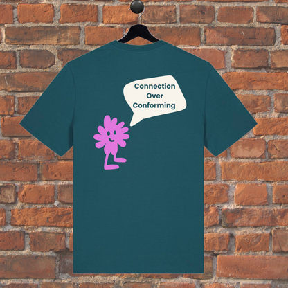 Green t-shirt with pink character and speech bubble on a brick wall background