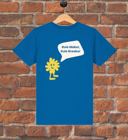 Blue t-shirt with yellow graphic and text on a wooden hanger against a brick wall.