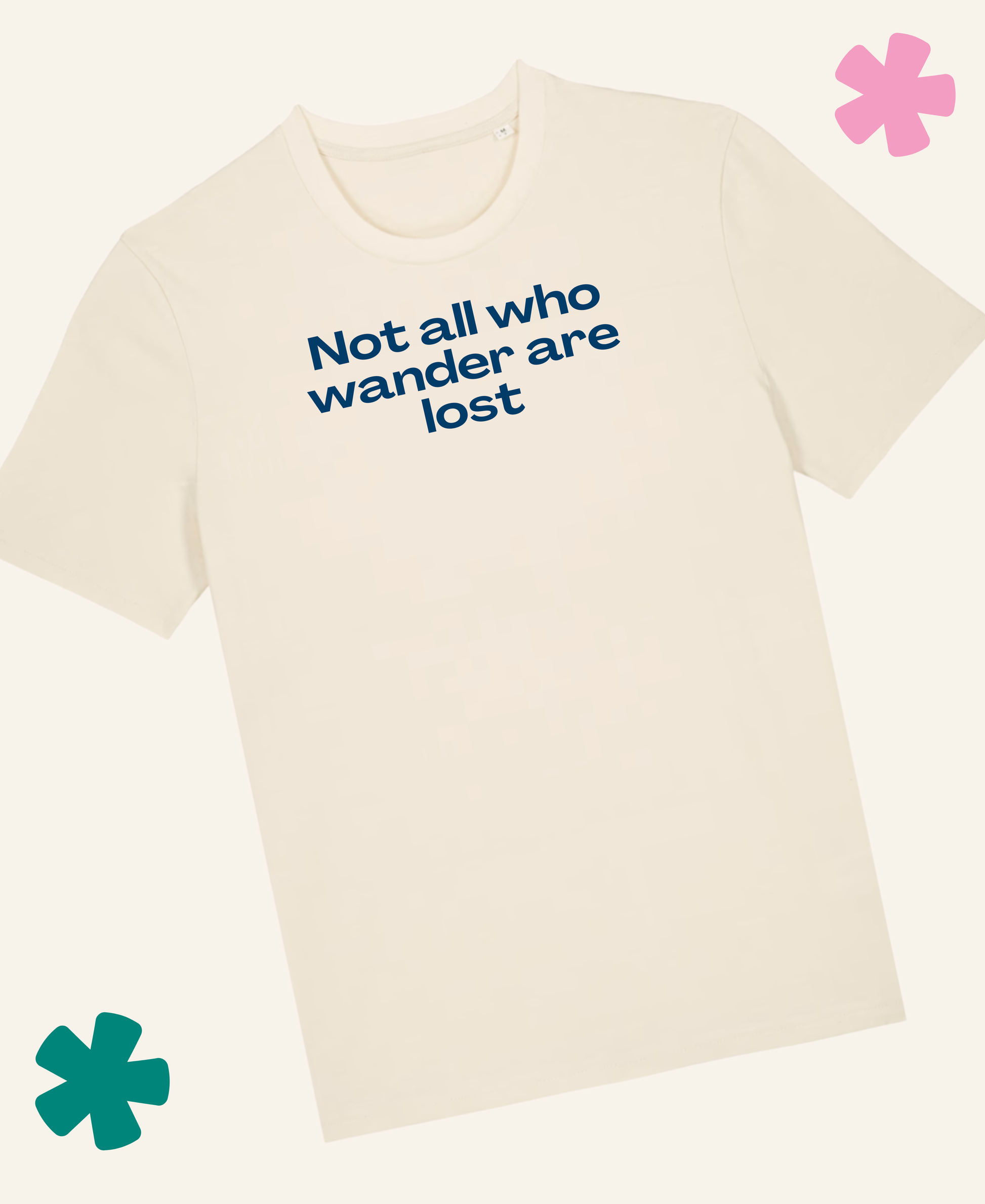 A natural raw crewneck t-shirt with the phrase 'Not all who wander are lost' printed in blue text across the chest, displayed on a matching off-white background with decorative pink and teal flower graphics in the corners. Unite Club x Something Profound