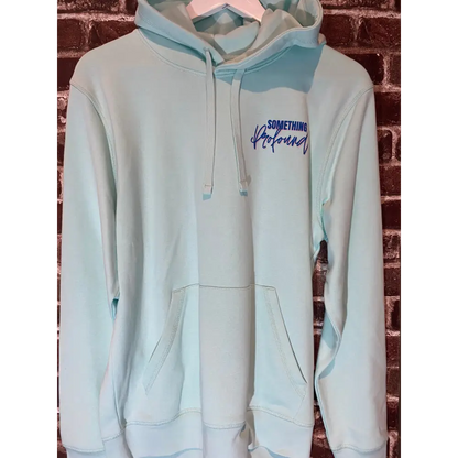 Caribbean blue hoodie with text on a brick wall background