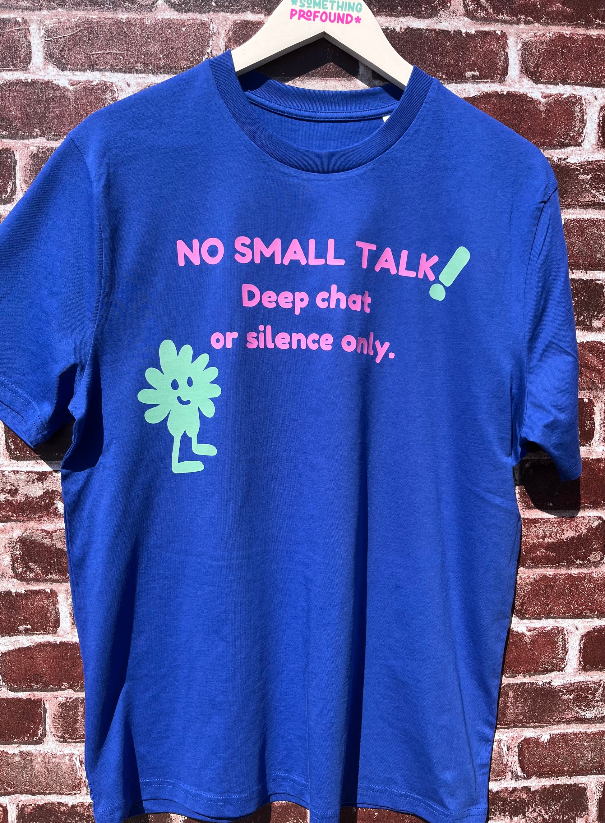 Blue t-shirt with text and graphics on a brick wall background