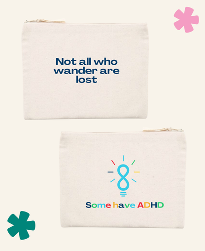 Two off-white canvas zippered pouches shown on a light cream background. The top pouch has the text 'Not all who wander are lost' printed in dark blue.