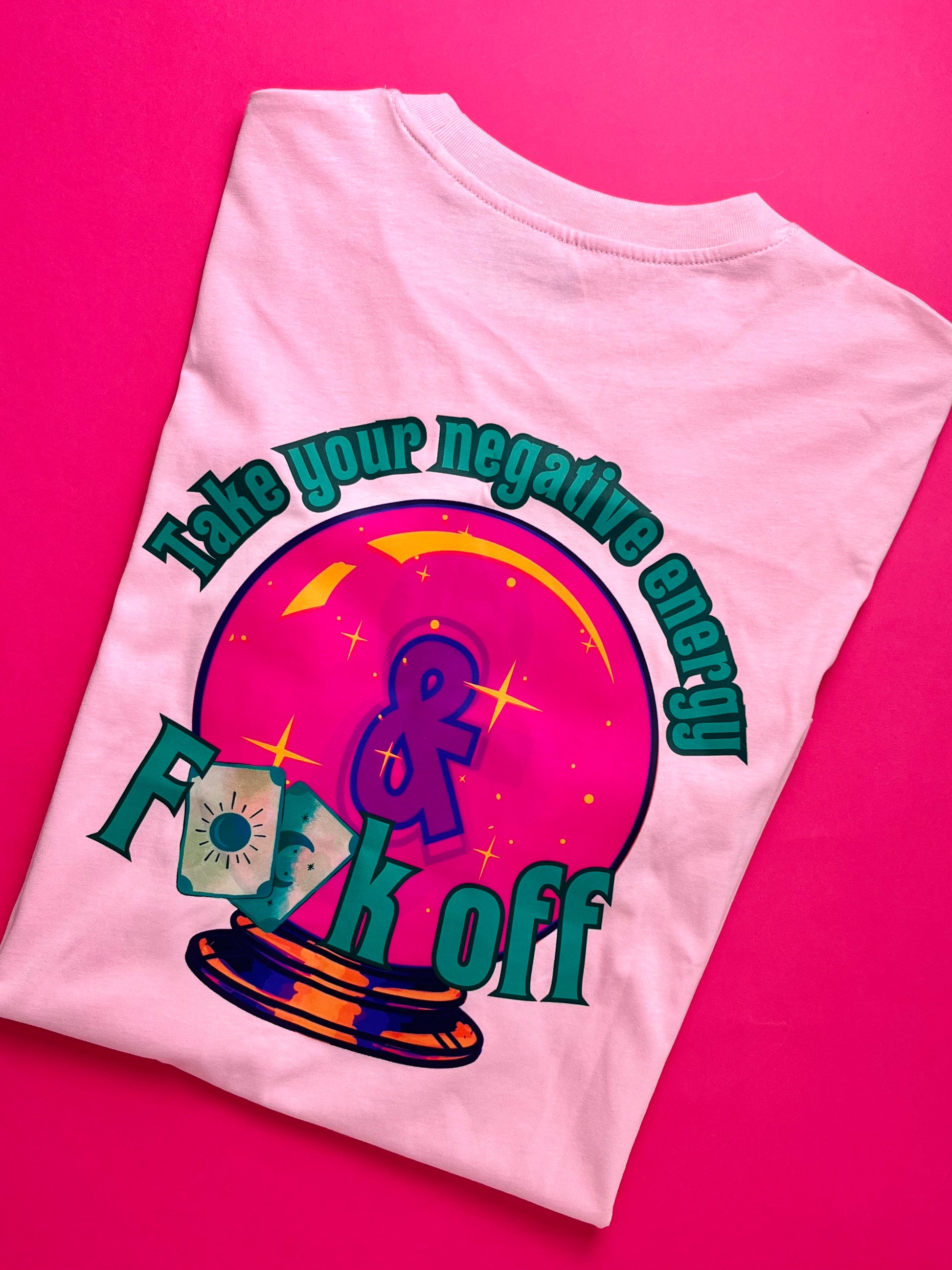 Pink t-shirt with colorful graphic design and text on a pink background