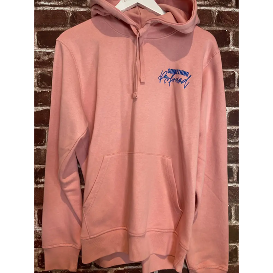 Pink hoodie with blue text on a textured surface