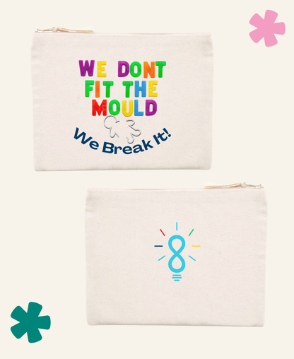 Two cream canvas zip pouches shown on a light beige background. The top pouch has colourful text reading 'WE DON'T FIT THE MOULD We Break It!' with a small white broken-clincher graphic.